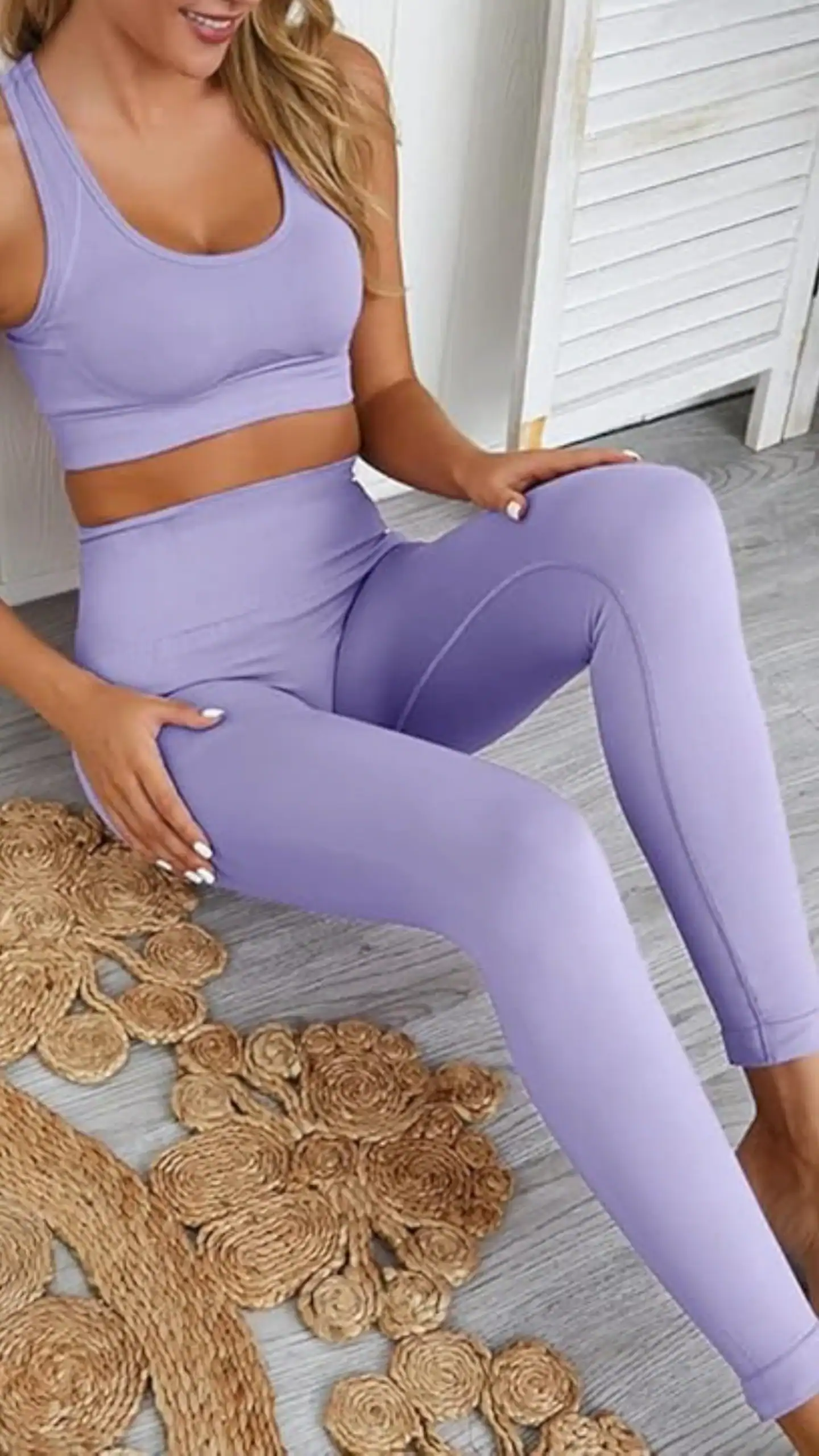 This two-piece workout set features a soft, high-quality lavender fabric with excellent elasticity, providing a seamless and slimming high-waisted fit in the leggings and a supportive racerback sports bra with removable pads. Ideal for both exercise and lounging, this minimalist yet stylish ensemble strikes a balance between comfort and functionality, making it perfect for casual outings or home workouts.