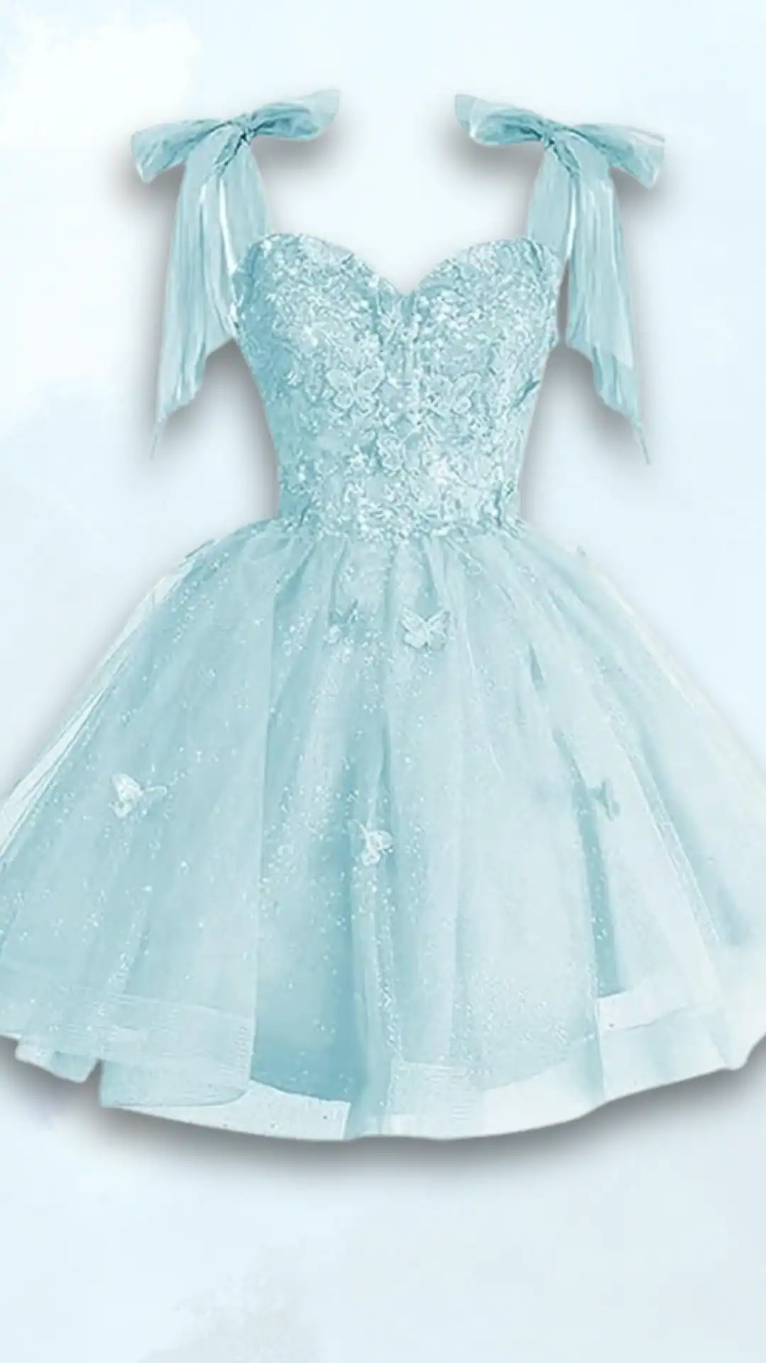 This enchanting homecoming dress features a light blue hue with delicate butterfly embellishments and a fitted, corseted bodice adorned with intricate lace details. The voluminous skirt is created from a textured tulle, offering a playful and ethereal vibe, perfect for teenage girls attending formal events or school dances.