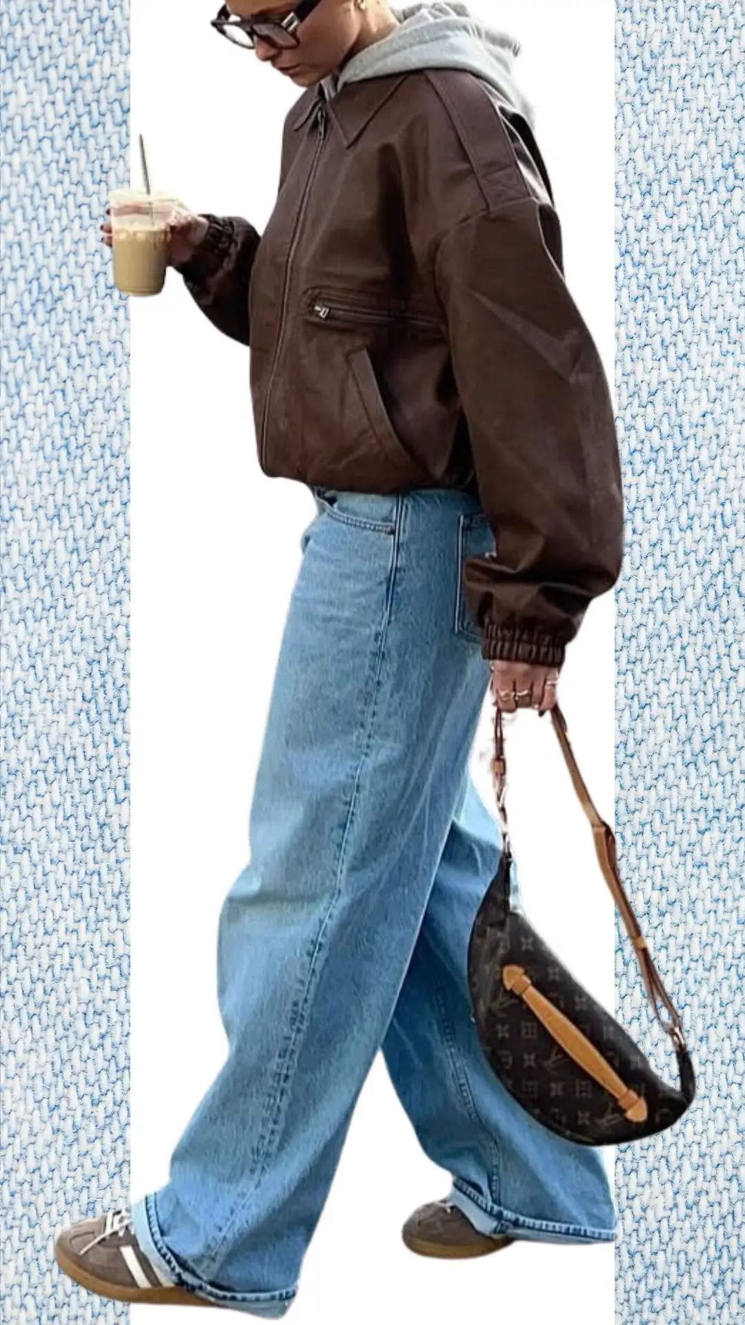 The outfit features light blue wide-leg jeans made of soft denim, paired with a cozy gray hoodie layered under a rich brown bomber jacket in a smooth fabric, providing warmth for colder months. Accessories include a stylish brown handbag with a chic design and casual sneakers for comfort, creating a trendy look suitable for winter transitioning into spring.