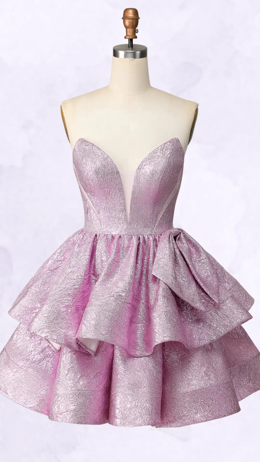 This homecoming dress features a structured, sweetheart neckline with intricate detailing and a playful, voluminous skirt, crafted from a textured, shimmering lilac fabric. The design exudes a trendy and youthful vibe, perfect for formal events or school dances, tailored for teenage girls seeking a bold and fun statement piece.