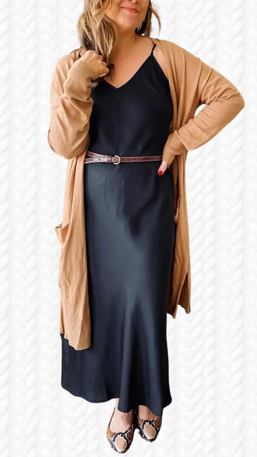 The outfit features a flowing black slip dress paired with a soft, light brown long cardigan, characterized by long sleeves and an open front. The cardigan's texture is cozy and knit-like, while the dress has a sleek, silky look. Completing the ensemble are stylish shoes with a snakeskin pattern, adding a touch of sophistication.