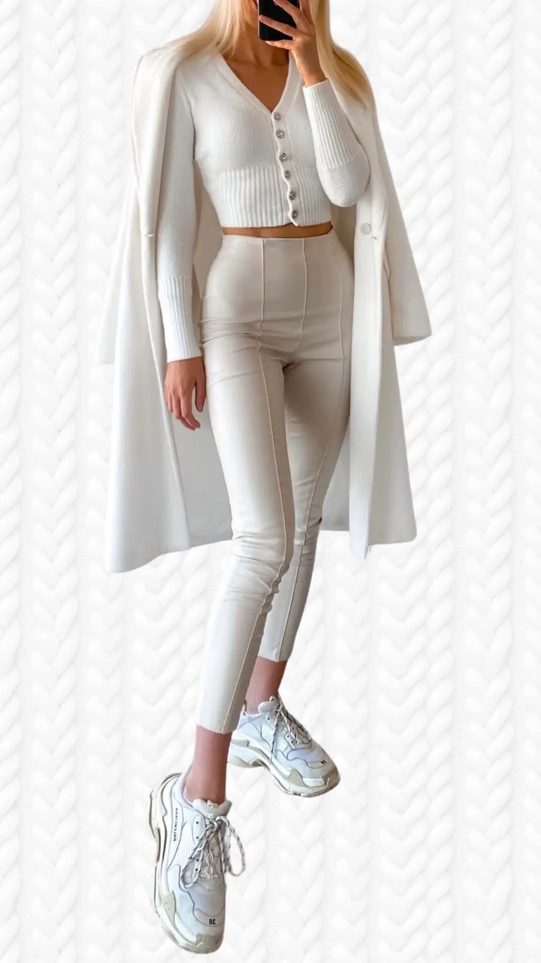 The outfit features a cropped white cardigan with a deep V-neckline and ribbed texture, accompanied by high-waisted, slim-fit cream-colored pants. White sneakers add a sporty touch, while the long cardigan drapes effortlessly, creating a stylish layered look. The ensemble showcases a clean, monochromatic color palette that enhances its modern elegance.