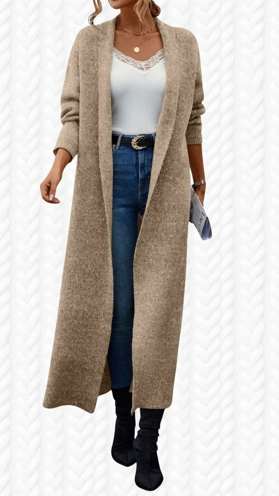 A long, beige cardigan made of a soft, textured fabric features an open front and relaxed fit, extending to mid-calf. The outfit includes a white tank top with delicate lace detailing at the neckline and high-waisted dark blue jeans, complemented by sleek black ankle boots. Accessories include layered necklaces and a simple wristwatch, enhancing the overall stylish and cozy look.