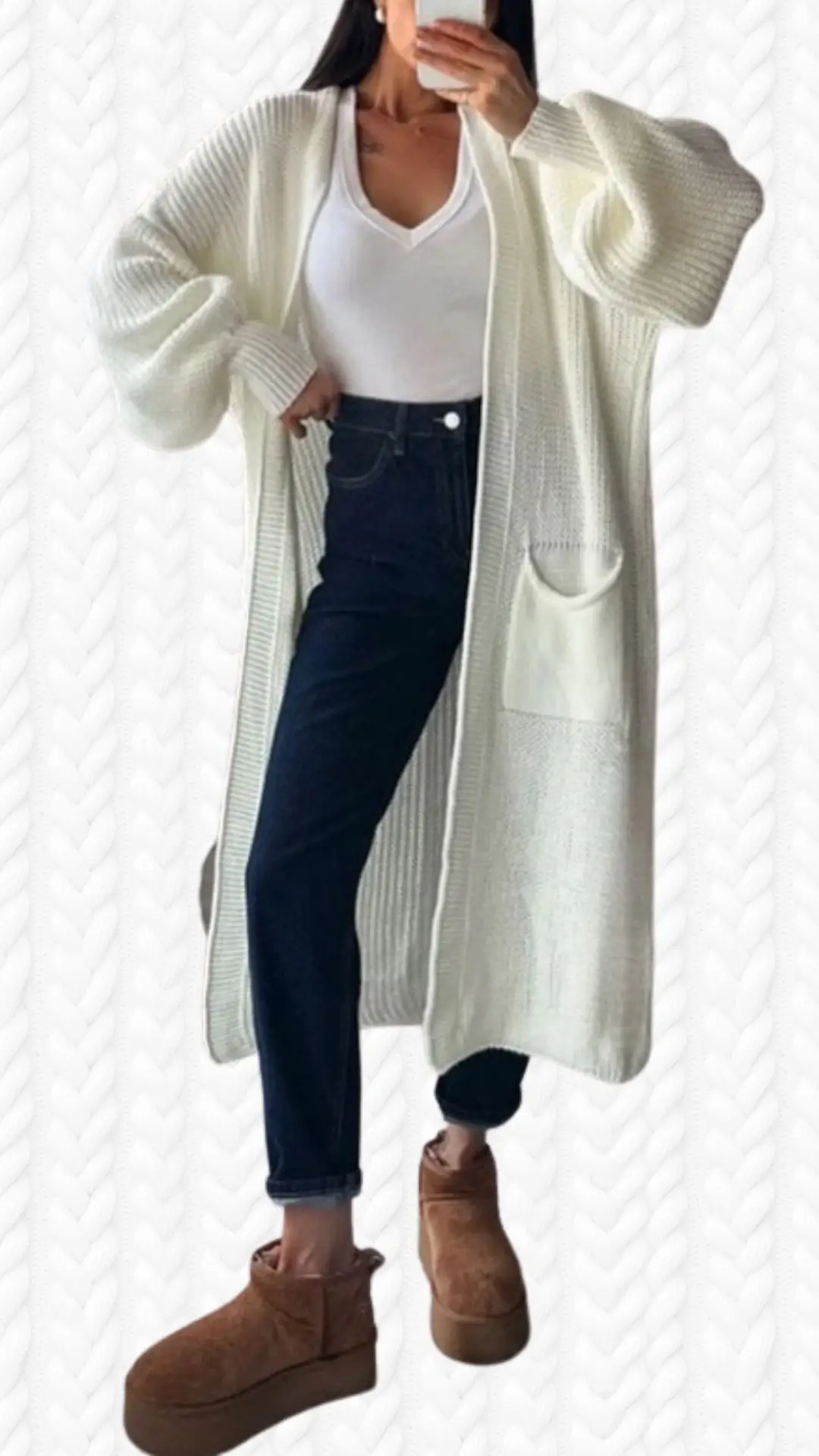 The outfit features a cozy, long white cardigan with a textured knit pattern and oversized sleeves, layered over a fitted white v-neck top. Paired with dark blue high-waisted jeans, the look is completed with trendy tan platform ankle boots. Subtle details include a front pocket on the cardigan and a soft material that enhances the overall chic and comfortable aesthetic.