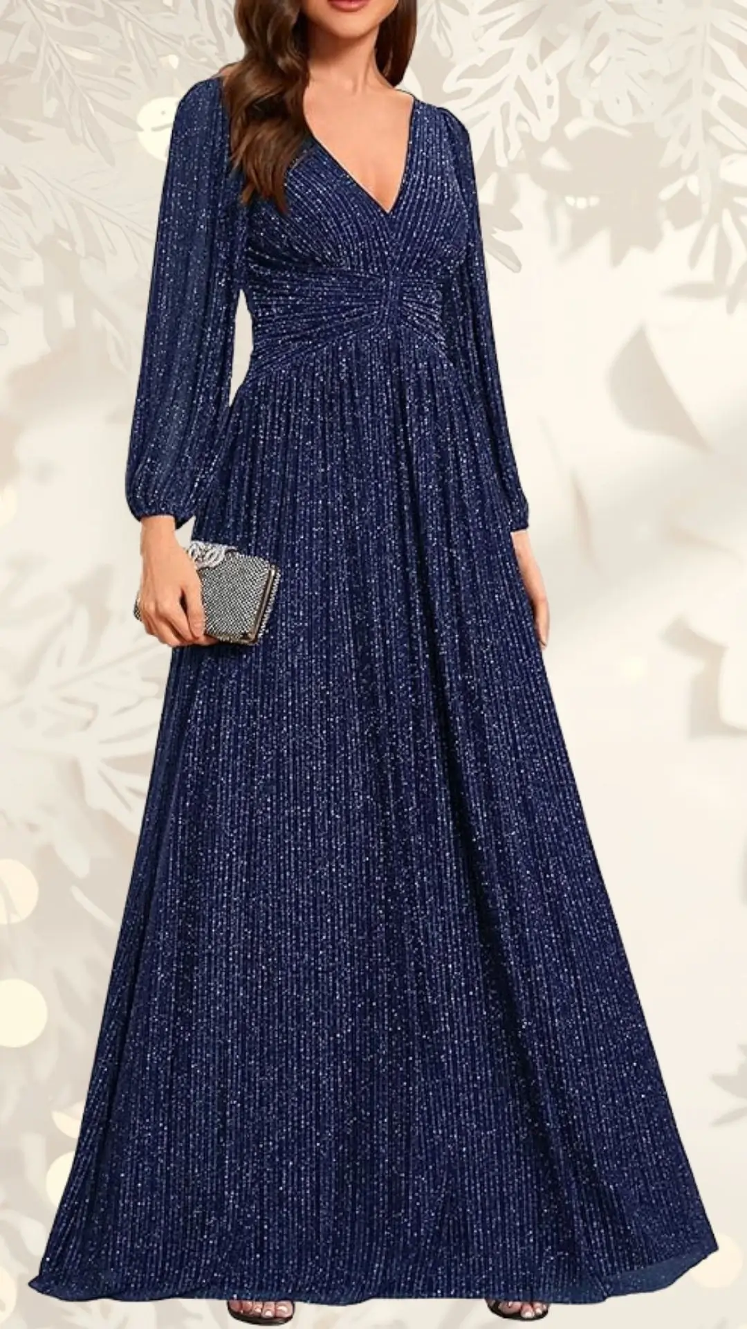 The long sleeve wedding guest dress features a deep V-neckline and a fitted bodice with vertical pleats, flowing into a full, ankle-length skirt. Made of a shimmering navy fabric, the dress has long, billowy sleeves and is complemented by a small, embellished clutch in the model's hand. The overall style exudes elegance and sophistication, suitable for formal occasions.