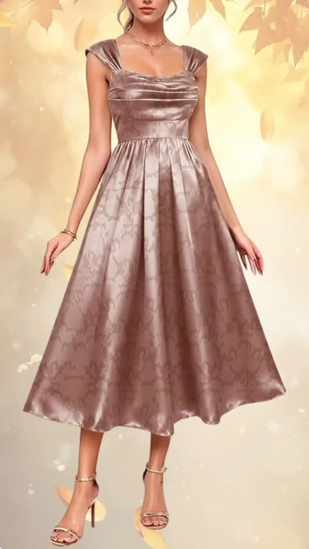 A luxurious satin wedding guest dress features a soft, muted mauve color with a subtle floral pattern. The dress has wide shoulder straps and a fitted bodice that flows into a knee-length, A-line skirt, emphasizing elegance and movement. Paired with strappy high-heeled sandals, it creates a sophisticated and graceful look suitable for fall occasions.