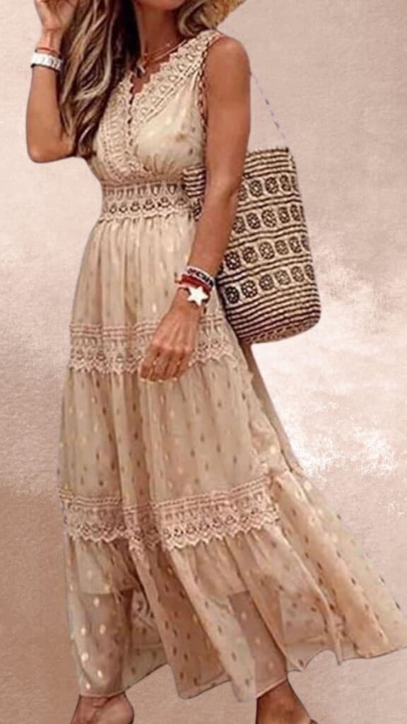 The dress features a flowy, beige fabric with subtle polka dots and intricate lace detailing along the waist and hem, exuding a charming country western vibe. It has a V-neckline and a sleeveless design that accentuates a relaxed silhouette, making it an elegant choice to pair with cowboy boots. The model complements the look with a woven bag and layered bracelets for a rustic yet stylish ensemble.