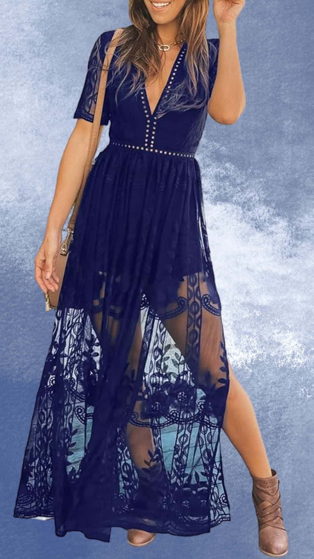 A navy blue maxi dress with a deep V-neckline and short sleeves features intricate lace detailing that cascades down the sides, revealing a flowy silhouette. It is styled with a subtle belt of studs, perfectly pairing with rustic brown cowboy boots for an elegant country western look. The dress flows gently with movement, embodying both sophistication and a laid-back charm.