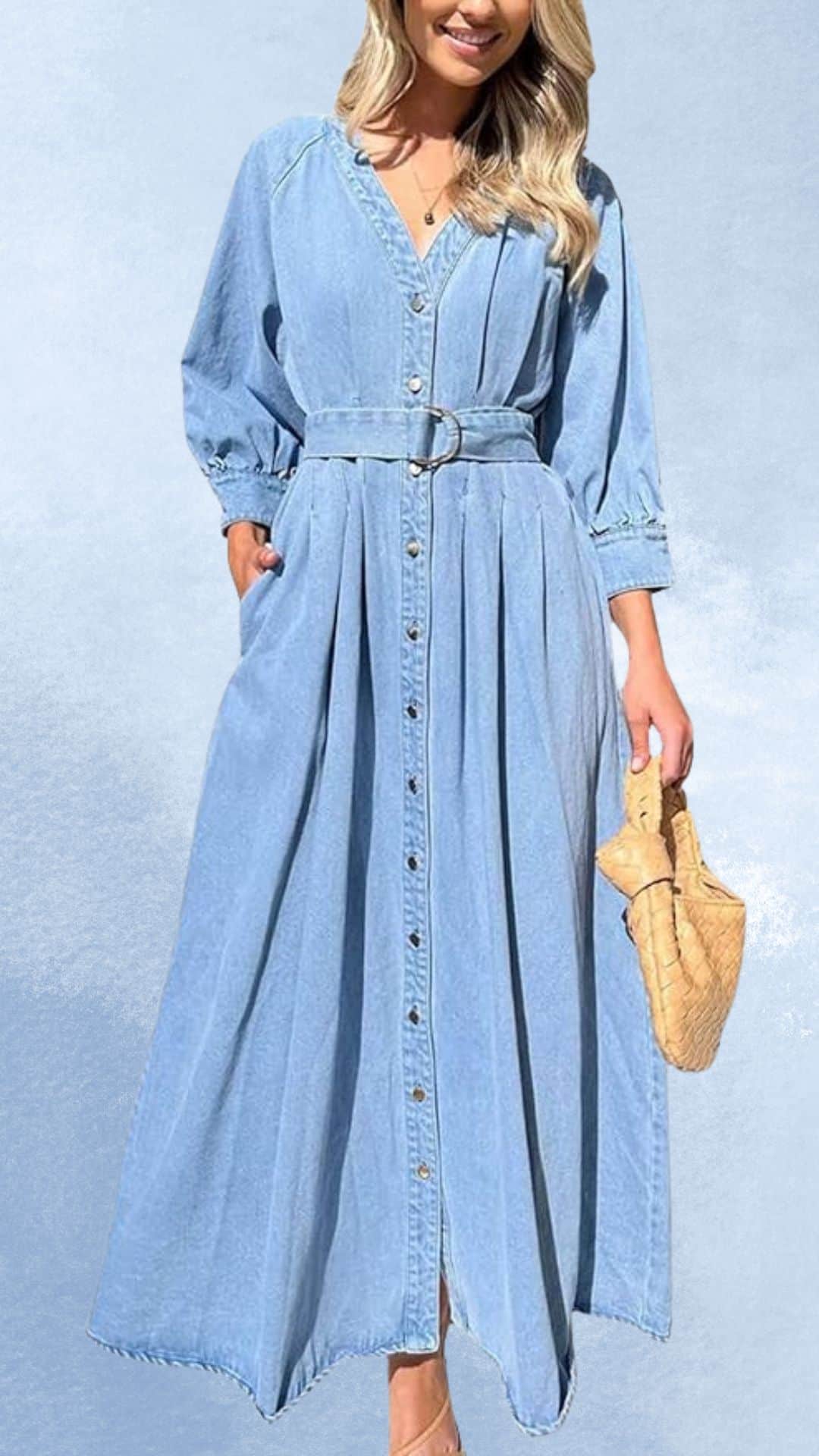 A stylish, long, light blue denim maxi dress features a deep V-neckline and puffed sleeves, with a belted waist that enhances its silhouette. The dress showcases a row of buttons down the front, creating a chic, country western vibe, making it an elegant pairing option for cowboy boots. Ideal for outdoor gatherings, it radiates a casual yet refined aesthetic.