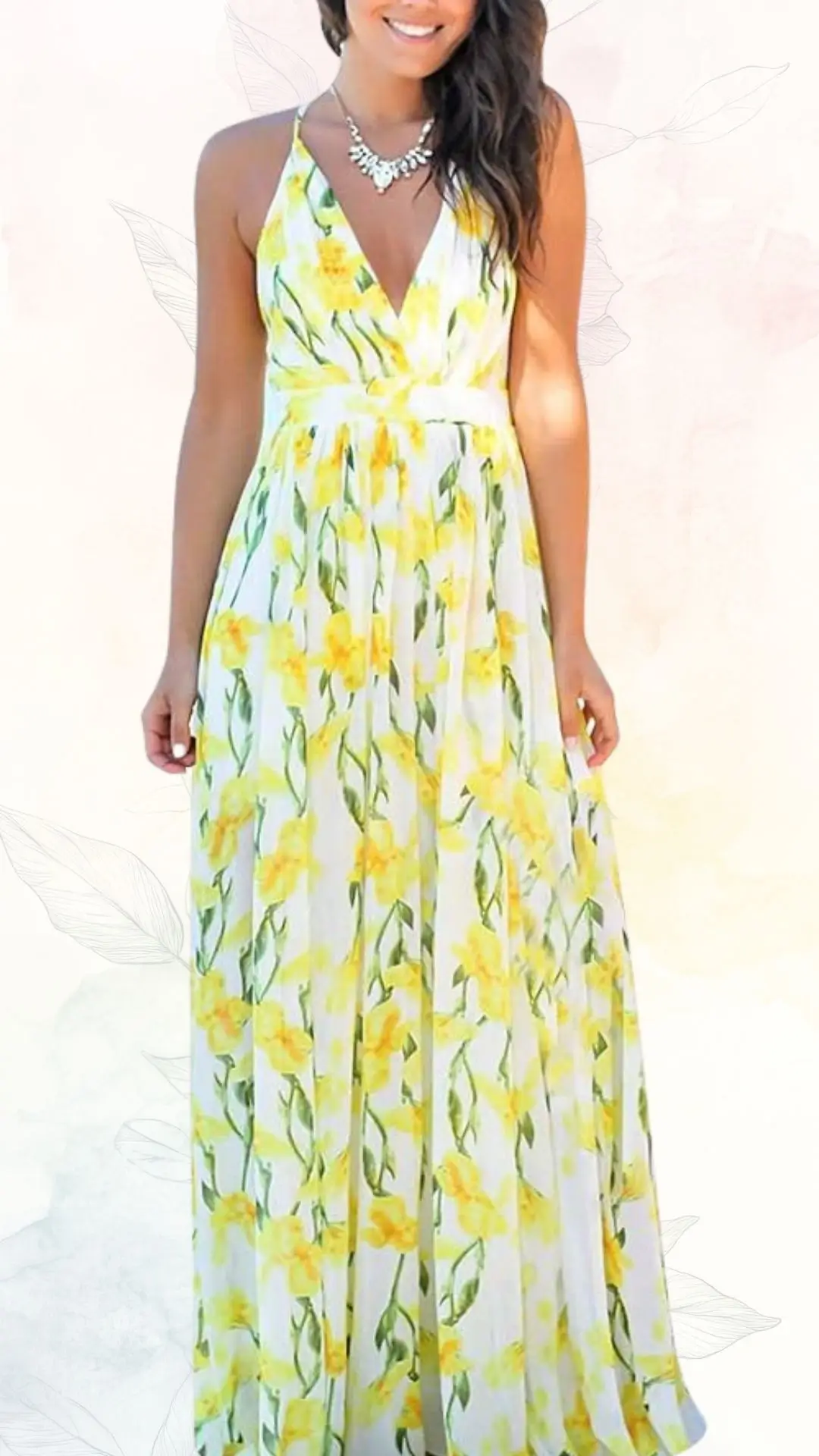 A sleeveless summer maxi dress features a deep V-neckline and a fitted waist, adorned with a vibrant yellow floral pattern against a light white background. The flowing fabric creates an elegant silhouette, perfect for wedding guests or outdoor events. A simple necklace complements the look, enhancing the dress's fresh and cheerful aesthetic.