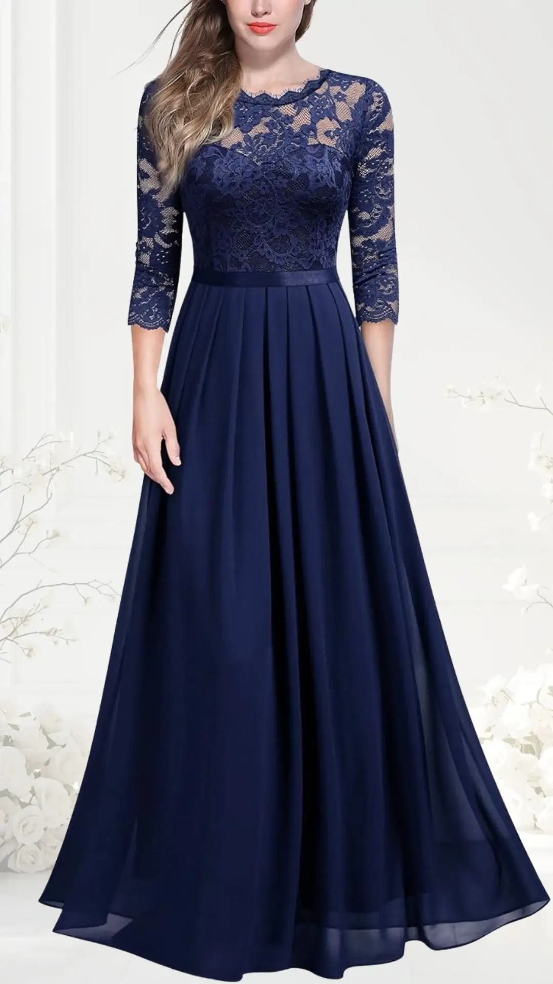 A navy blue wedding guest dress features a lace fitted bodice and three-quarter sleeves, transitioning into a flowing, long skirt. The design combines elegance with a classic silhouette, suitable for formal occasions. Lightweight fabric enhances its graceful movement.