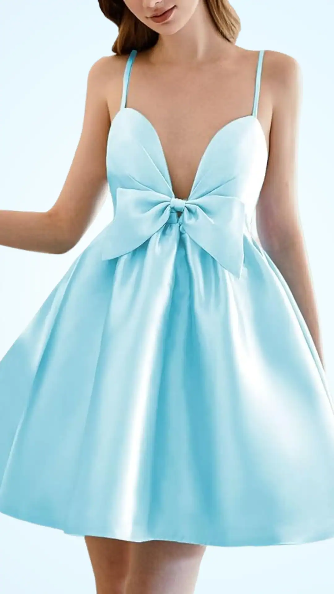 This homecoming dress features a playful A-line silhouette in a soft, pastel blue satin, showcasing a deep V-neckline and delicate spaghetti straps. The design includes a prominent bow detail at the waist, creating a youthful and whimsical vibe, perfect for a festive school dance or party occasion for teenage girls.
