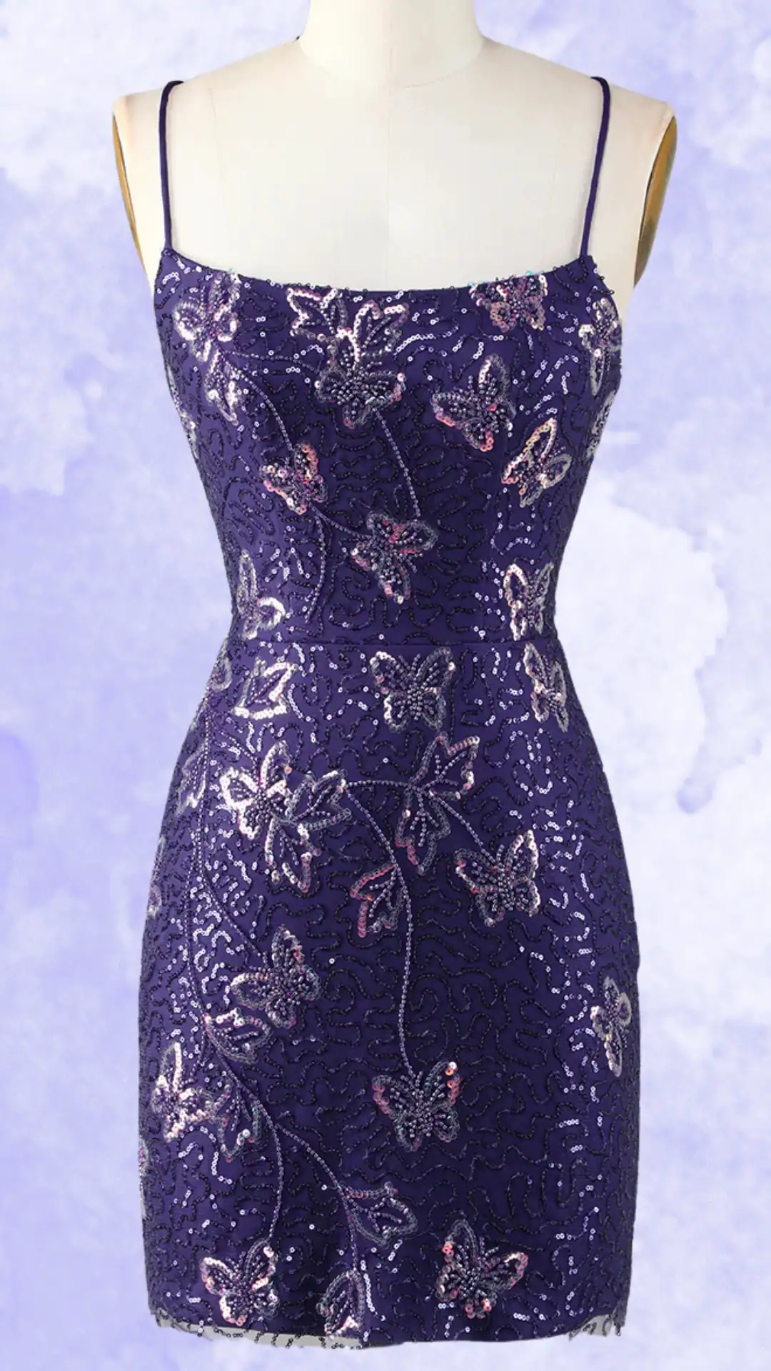 This fitted, purple homecoming dress features a delicate, sequined floral design intertwined with elegant butterfly motifs on a shimmery fabric, creating a textured and vibrant appearance. Its classic spaghetti straps enhance its femininity, making it an ideal choice for a teenage girl looking to make a bold yet romantic statement at a formal event or school dance.