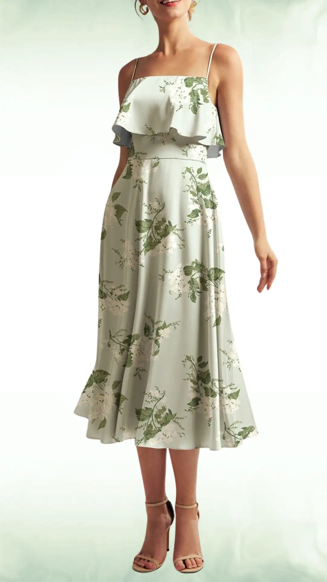 Sage green fall wedding guest dress featuring a delicate ruffled overlay, botanical prints of white flowers, green leaves, and a flattering A-line silhouette. Perfect for formal events.