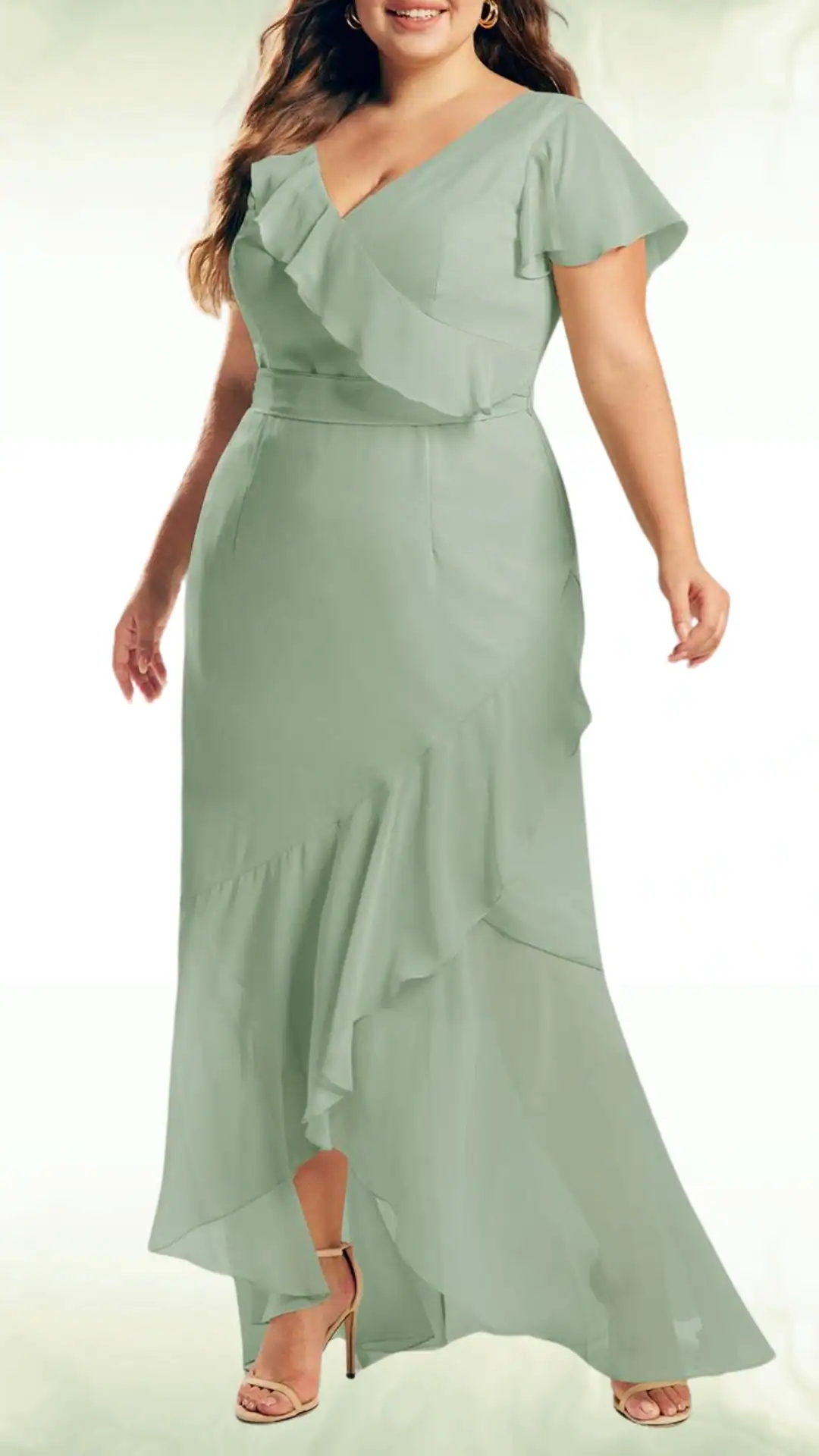 Sage green fall wedding guest dress featuring a flowing silhouette with ruffled details on the bodice and a layered asymmetrical hem, perfect for a romantic vibe at formal events.