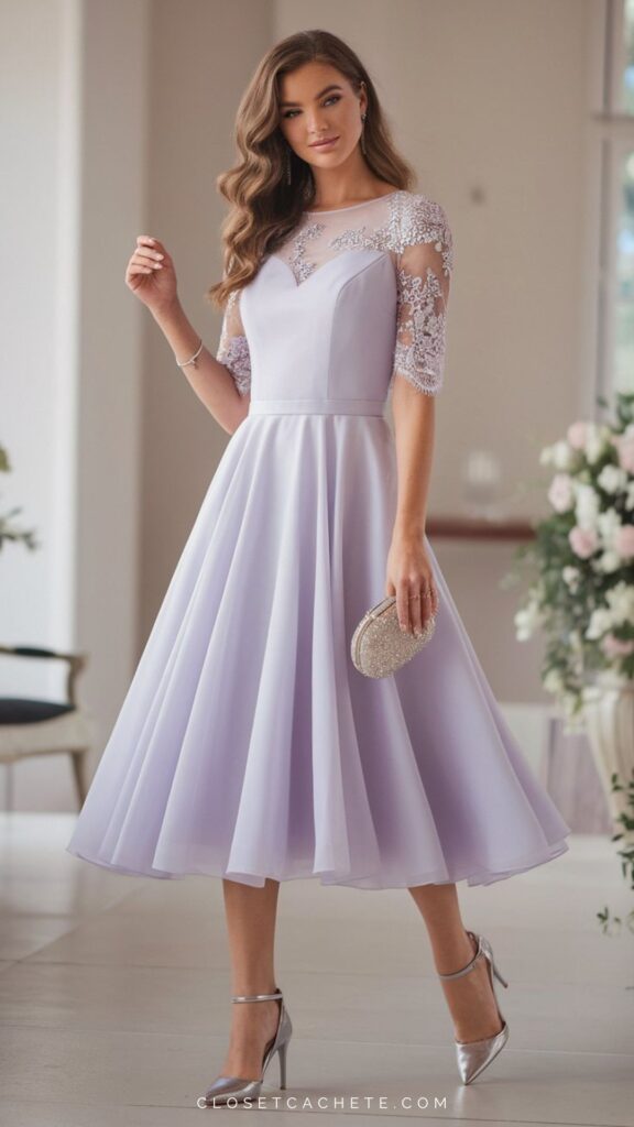 The outfit features a classy lilac midi dress with a fitted bodice and elegant sheer lace sleeves adorned with floral embellishments. Paired with silver high-heeled shoes and a matching embellished clutch, this ensemble is perfect for semi-formal occasions, exuding both sophistication and femininity.