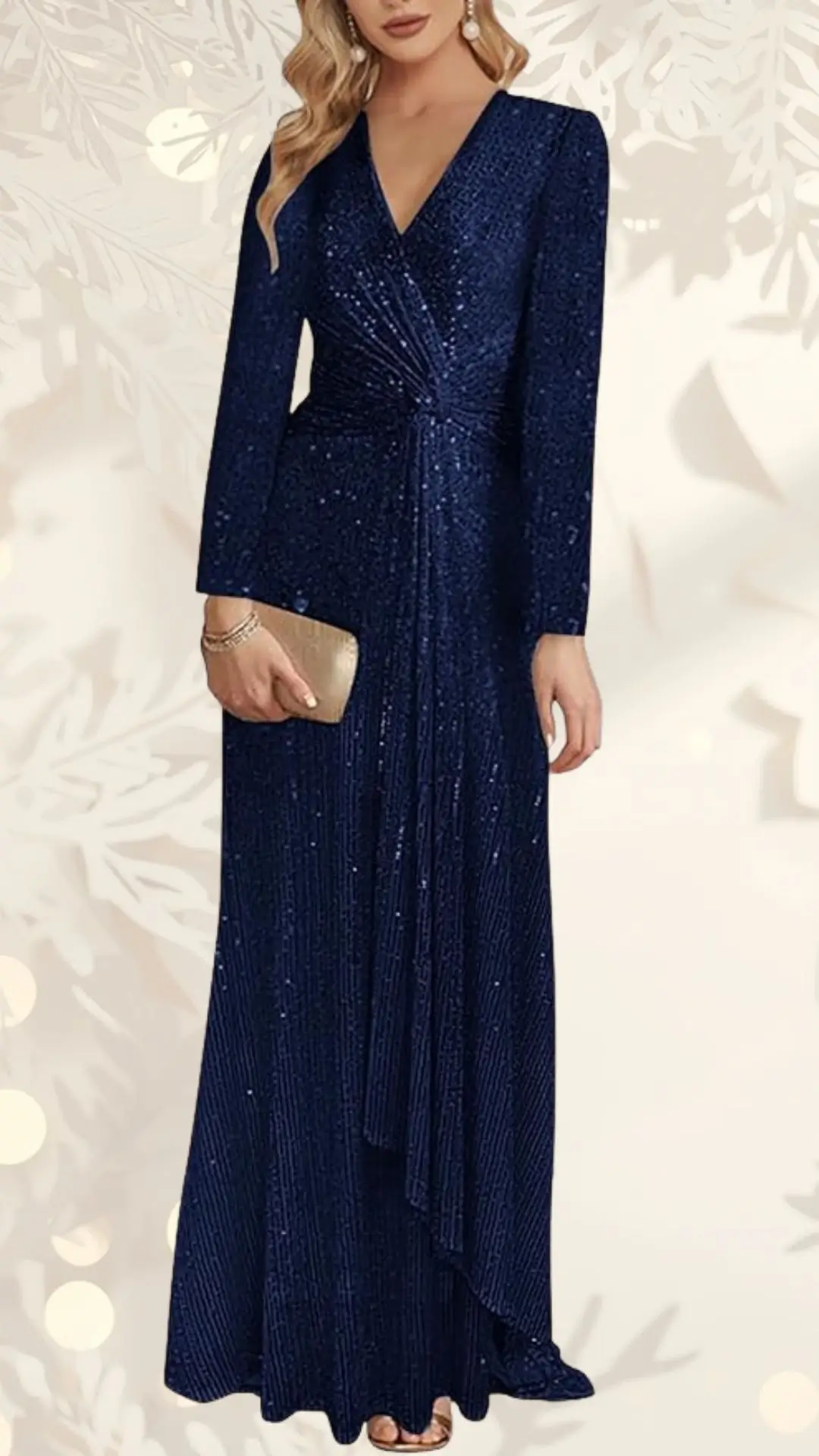 A shimmering navy blue sequin wedding guest dress features a deep V-neckline and long sleeves, elegantly draped across the waist for a flattering silhouette. The dress flows to the floor with vertical pleats, enhancing its graceful movement, while the model accessorizes with a small gold clutch and subtle jewelry.
