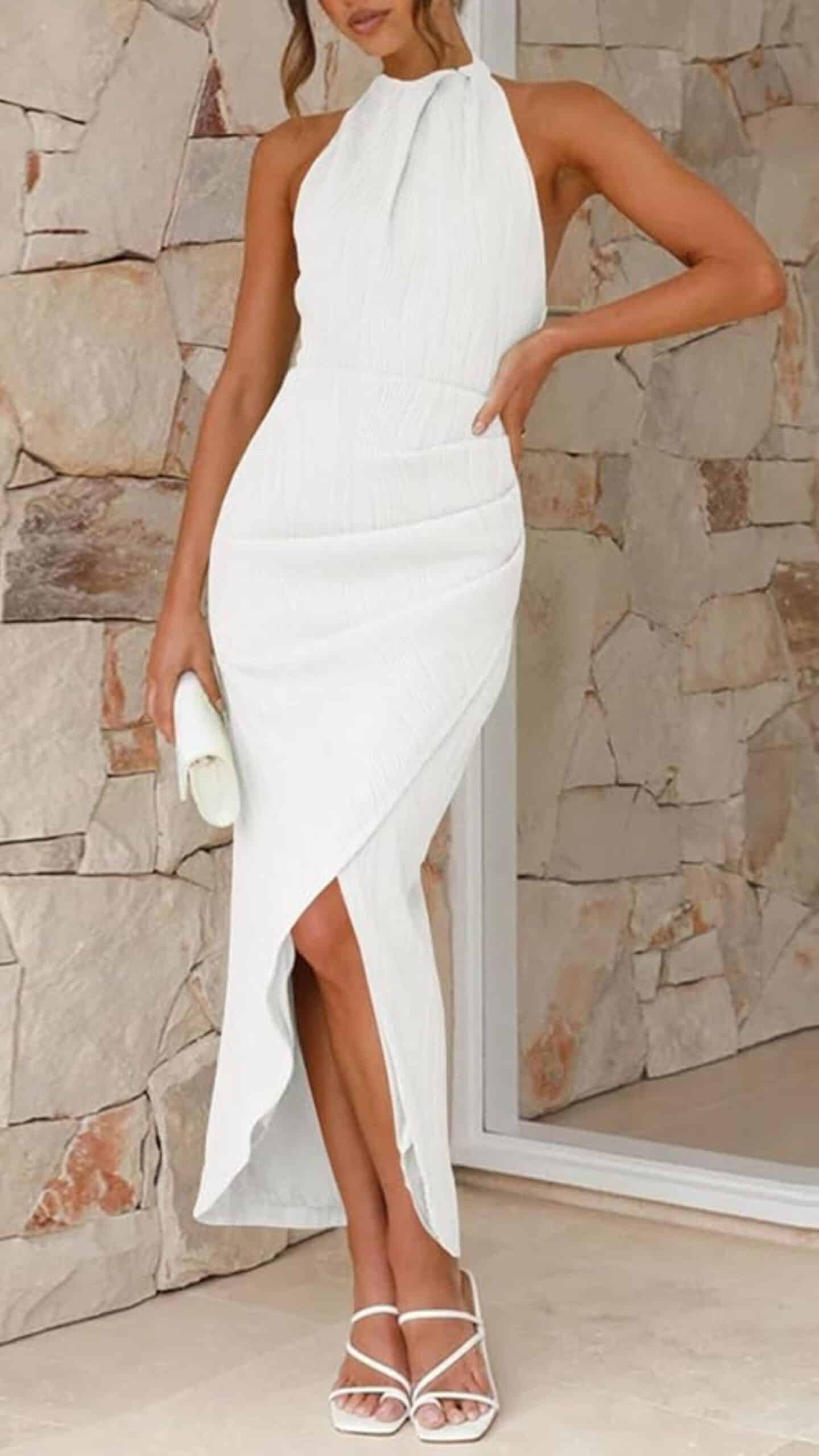 This sleek white dress features a figure-hugging silhouette with a halter neckline that ties at the back, highlighting the shoulders and arms. Made from a textured fabric, it showcases a full-length design with a high side slit, enhancing its elegant and contemporary appeal, making it suitable for formal occasions or upscale events.