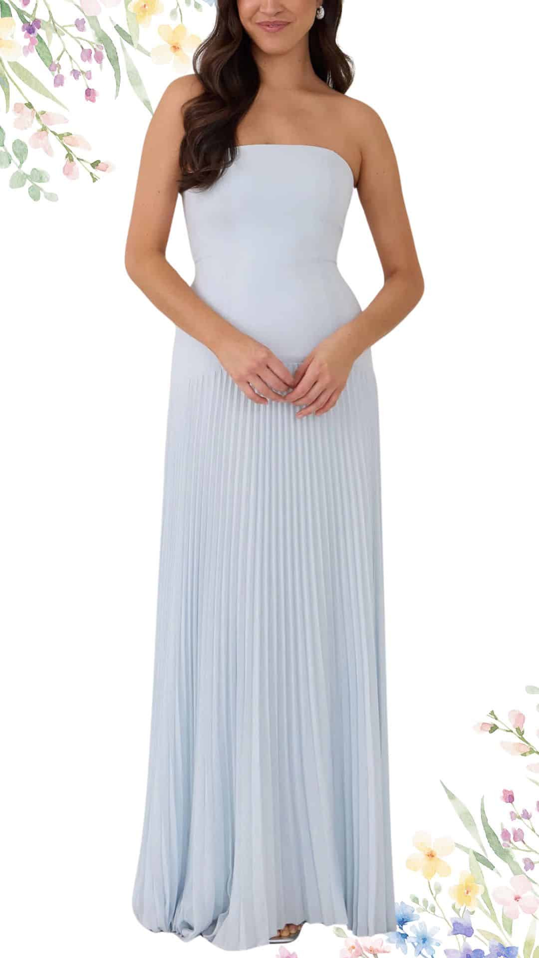 This elegant strapless maxi dress features a soft light blue hue, crafted from a lightweight, flowing fabric that drapes beautifully. The dress has a pleated design that adds texture, with a floor-length hemline that creates a graceful silhouette suitable for a spring wedding.