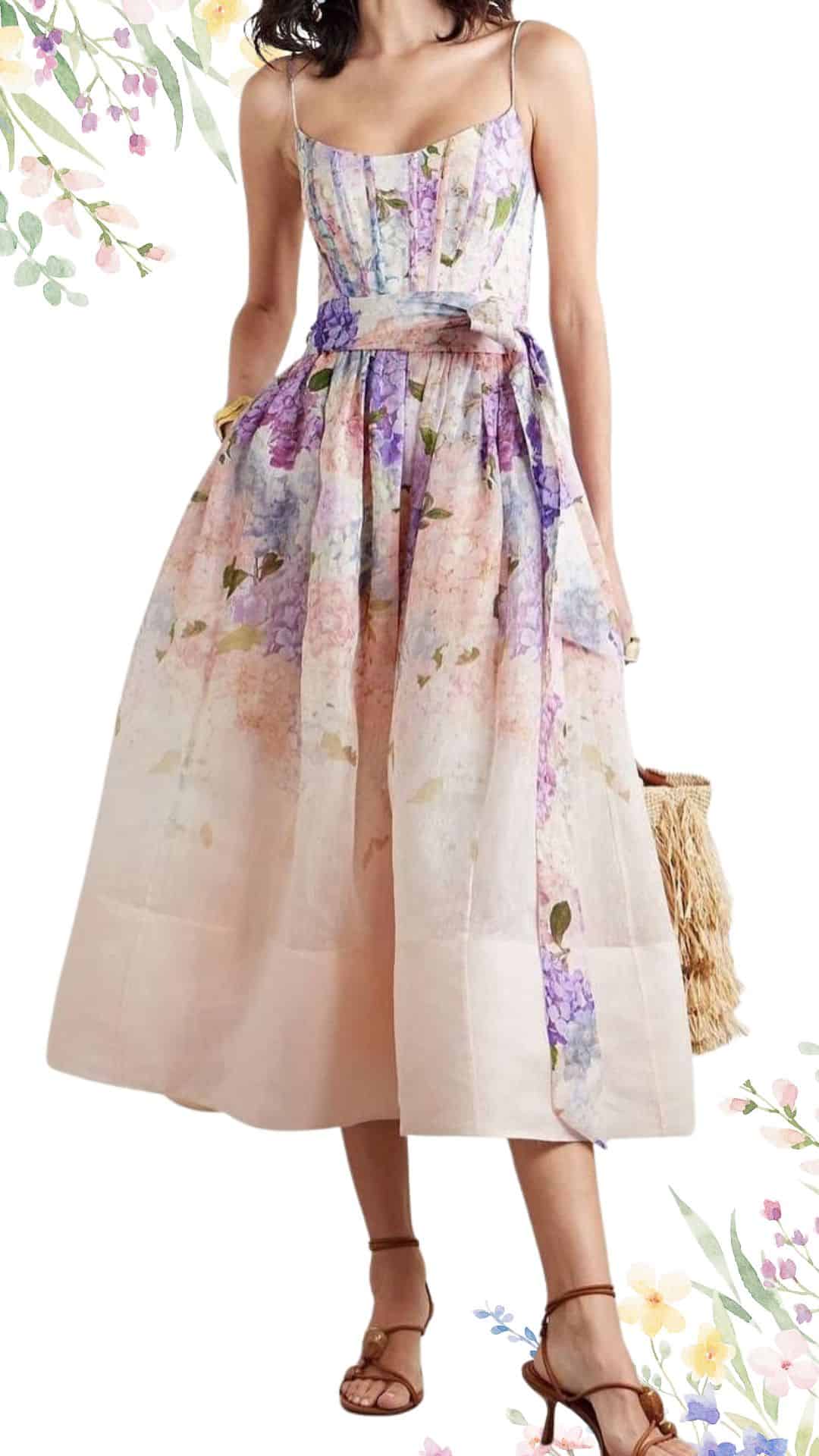 This elegant spring wedding guest dress features a fitted bodice with thin spaghetti straps and a flattering sweetheart neckline. The fabric showcases a soft blend of pastel colors, including shades of pink, lavender, and green, with a lightweight, flowing skirt that falls to mid-calf length with a subtle A-line silhouette. The dress is completed with a delicate waist tie, enhancing its gracefulness and feminine appeal.