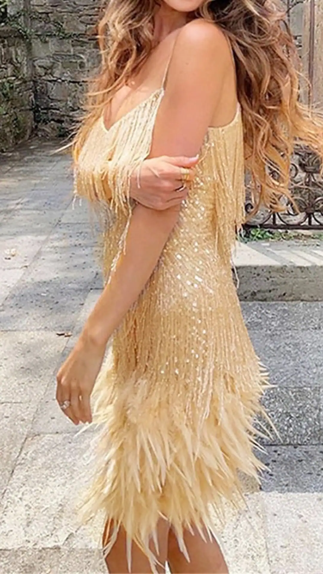 This stunning yellow homecoming dress features a figure-hugging silhouette enhanced by shimmering sequins and playful feather detailing at the hem, lending a bold and glamorous touch. The vibrant golden hue creates a striking, trendy vibe that is perfect for a lively party or school dance, making it an ideal choice for teenage girls looking to make a statement.