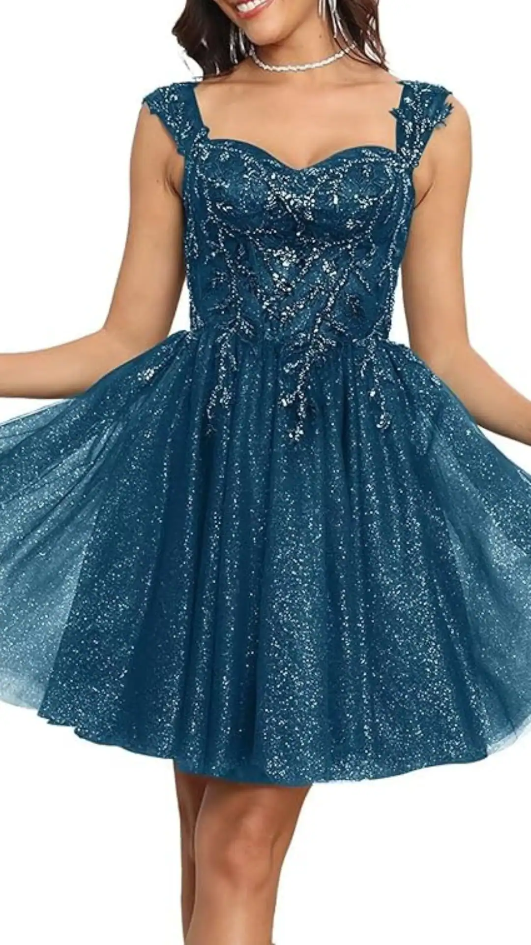 This teal homecoming dress features a fitted bodice adorned with intricate beading and shimmering embellishments, leading into a voluminous skirt made of layered, sparkly tulle for a playful yet elegant silhouette. The dress is designed for teen girls, perfectly suited for special occasions like homecoming or formal parties, exuding a trendy and enchanting vibe.
