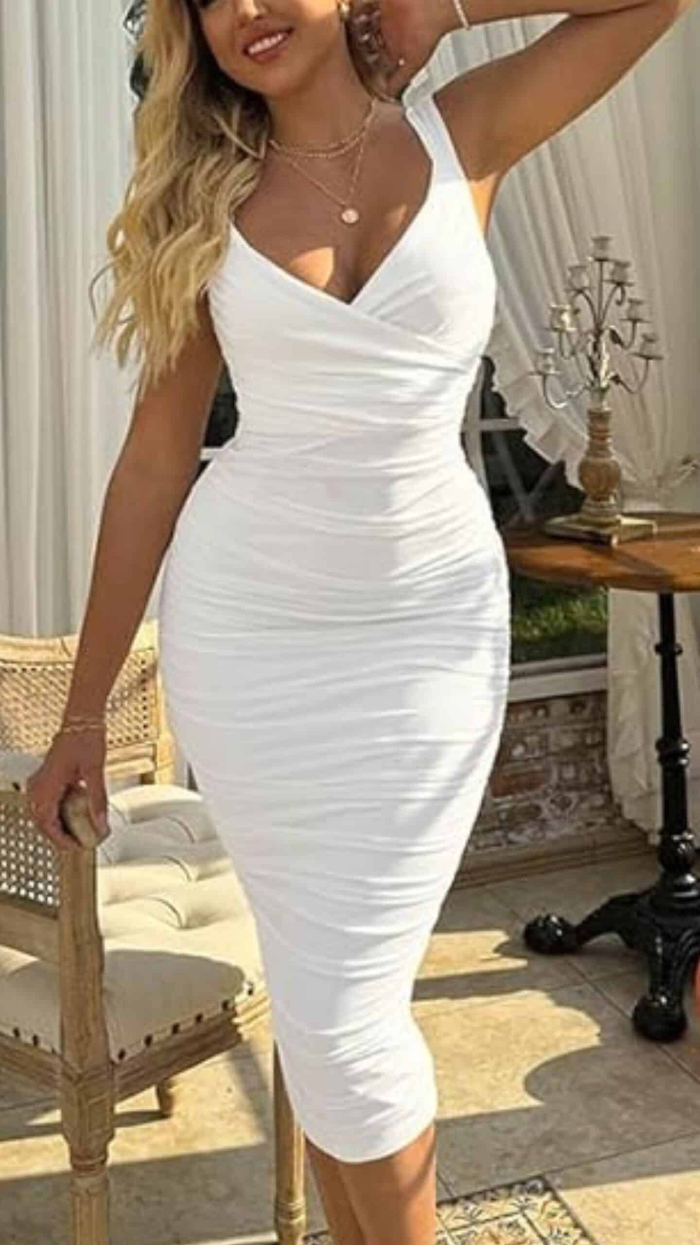 This white dress features a form-fitting silhouette with a V-neckline and thick straps, accentuating the figure while offering a modest yet stylish look. Crafted from a smooth, stretchy fabric with a matte finish, it falls to mid-calf length and showcases delicate ruching throughout, giving it a sophisticated and polished vibe, perfect for formal events or elegant outings.
