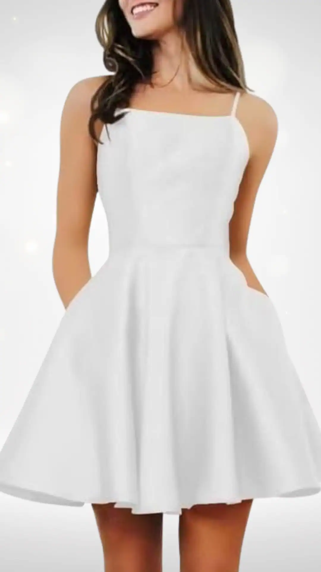 This white homecoming dress features a simple A-line silhouette with a fitted bodice and a flared skirt, crafted from a smooth, lightweight fabric that offers a clean, polished look. The dress showcases delicate spaghetti straps and practical side pockets, exuding a classic, playful vibe ideal for formal events or school dances, perfect for teens celebrating special occasions.