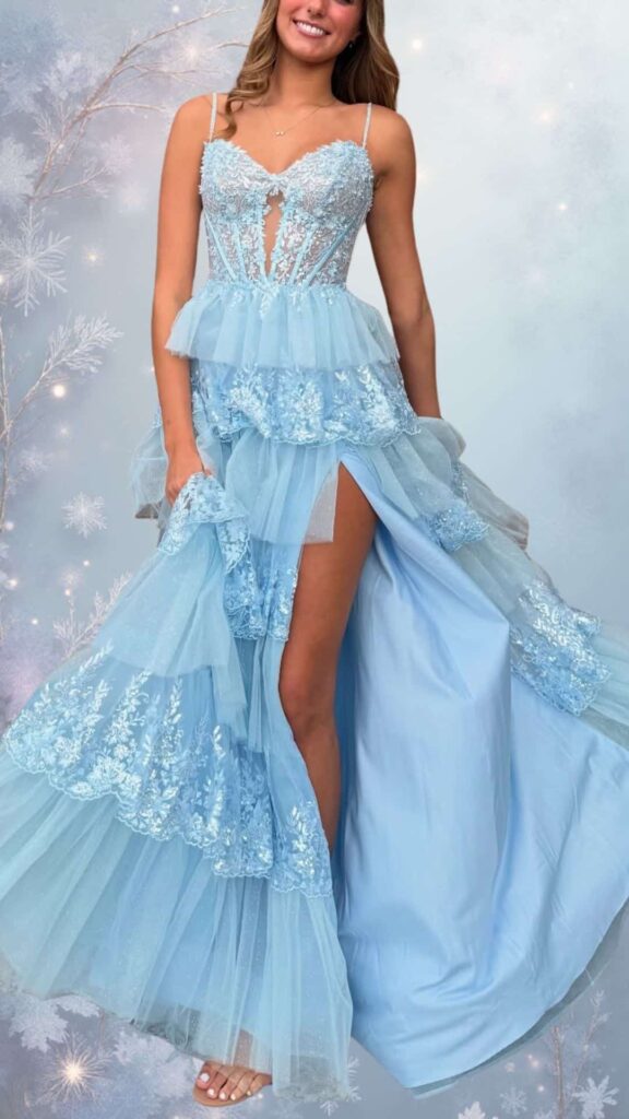 This winter formal dress features a fitted bodice with a sweetheart neckline and thin shoulder straps, showcasing intricate beadwork and floral lace in soft blue tones. It has a tiered skirt with flowing layers of delicate tulle, a thigh-high slit, and a playful, yet elegant silhouette, making it perfect for staying chic in cooler weather. The overall design combines warmth and style, ideal for a classy evening event.