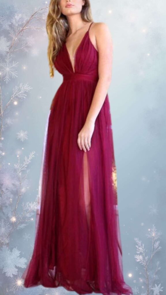This elegant winter formal dress features a deep V-neckline and thin adjustable straps, creating a flattering silhouette. The rich burgundy fabric has a soft, sheer overlay and ample movement with a full-length skirt that includes high side slits for added elegance. The dress exudes a chic yet cozy vibe, making it perfect for winter occasions.
