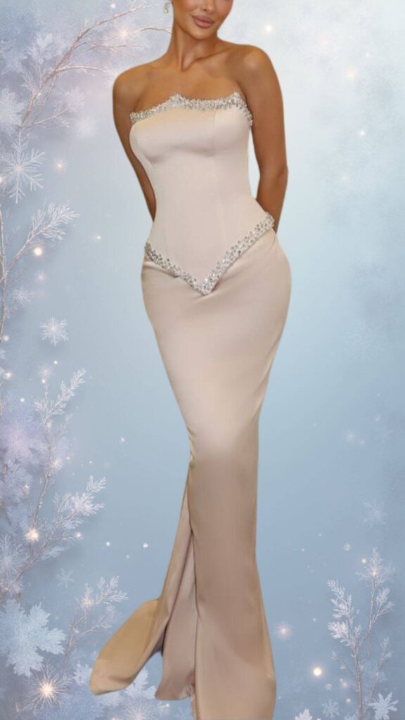 This elegant winter formal dress features a strapless sweetheart neckline and a fitted silhouette, crafted from a soft, smooth fabric in a light beige shade. The dress is embellished with delicate beadwork along the neckline and a flattering V-shaped detail at the waist, while a slight flare at the hem adds a graceful touch, making it suitable for chic outings in cooler weather.