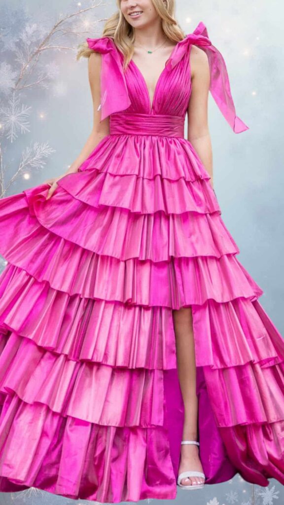 This vibrant fuchsia winter formal dress features a deep V-neckline and delicate, adjustable straps tied into bows at the shoulders. Its tiered skirt adds volume and movement, while the satin-like texture reflects light beautifully, making it an eye-catching choice for chilly weather. The dress also has a flowing silhouette that ensures elegance while allowing for layering underneath.