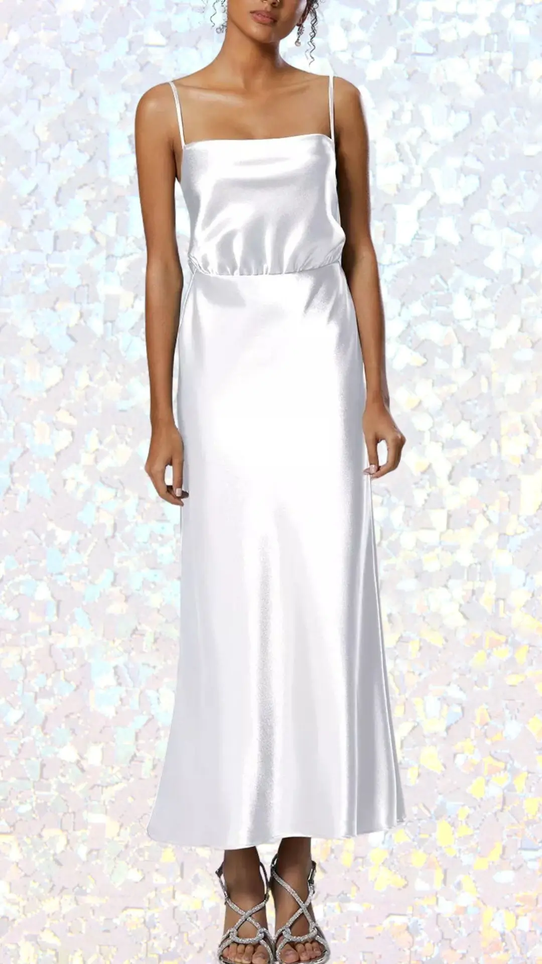 This elegant long winter formal dress features a sleek, satin fabric in a luminous shade of white, creating a sophisticated look. It has a graceful square neckline and delicate spaghetti straps, with a fitted bodice that flows into a subtly flared skirt. The minimalist design is complemented by a softly gathered waist, enhancing its timeless appeal for a winter formal occasion.