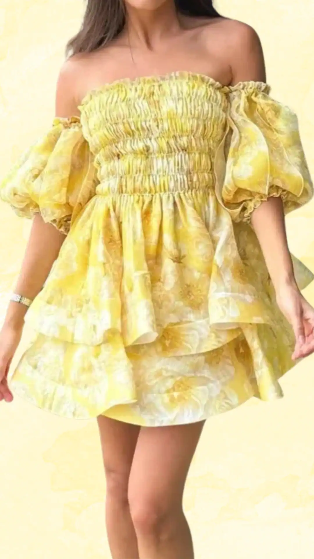 This vibrant yellow homecoming dress features a smocked bodice and voluminous puff sleeves, creating a playful and youthful silhouette perfect for a school dance. The textured fabric showcases delicate floral patterns in lighter shades, enhancing its cheerful and romantic vibe, making it an ideal choice for teens looking to make a statement.