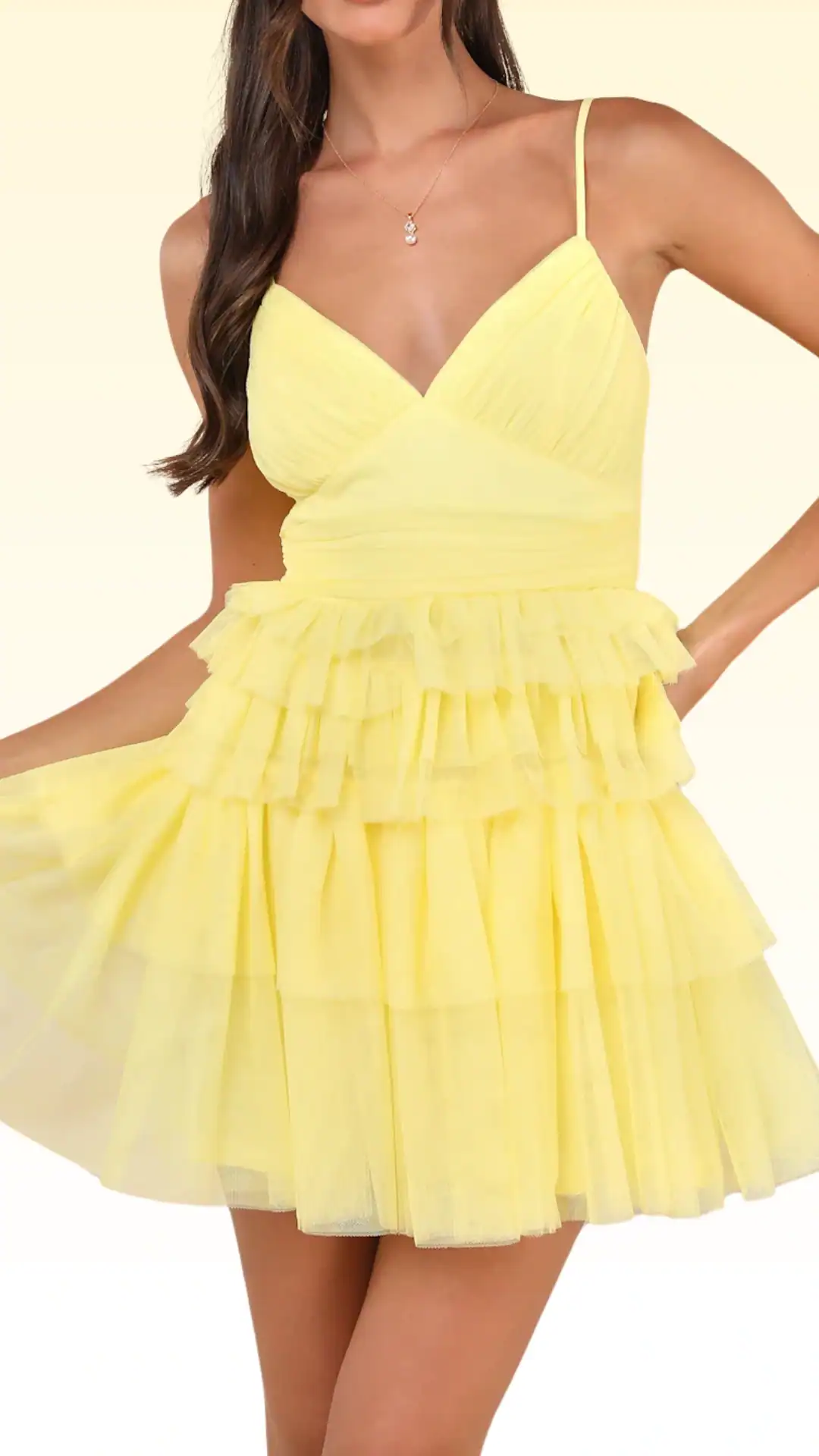 This vibrant yellow homecoming dress features a fitted bodice with a deep V-neckline and delicate spaghetti straps, complemented by a playful, layered tulle skirt that adds volume and movement. The overall aesthetic is youthful and whimsical, making it perfect for a party or school dance, tailored for teenage girls looking to make a cheerful and stylish statement.
