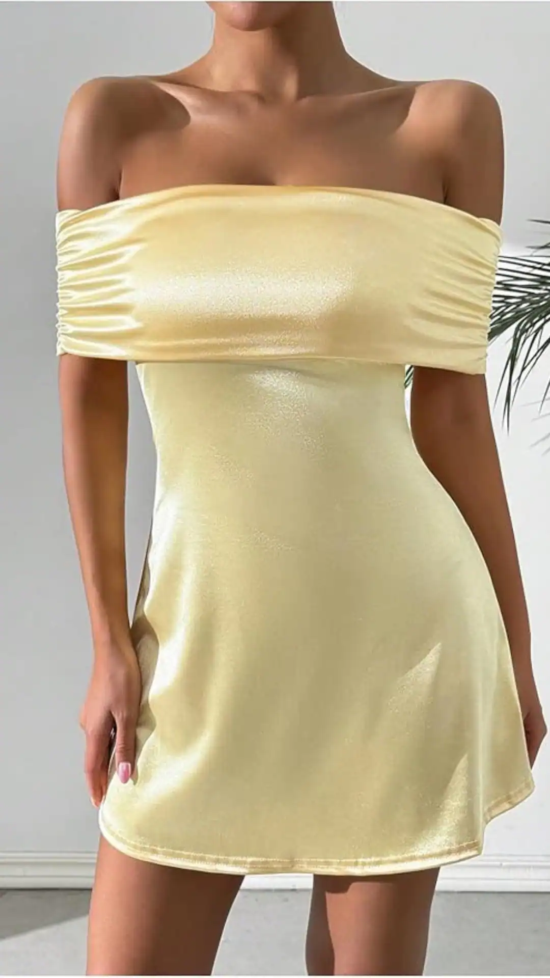 This yellow homecoming dress features a fitted, off-the-shoulder design with a soft shimmer and smooth texture, creating a sleek silhouette that hugs the body before flowing into a subtly flared hem. The playful yet elegant vibe makes it ideal for formal events like homecoming or school dances, perfect for teenage girls seeking a trendy and youthful look.