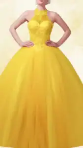 The dress features a vibrant yellow hue with a fitted bodice adorned with intricate floral lace details and a high neckline, accentuating elegance. The voluminous skirt flows to the floor, adding a dramatic flair with layers of tulle for a captivating silhouette. This Quinceañera dress combines style and grace, perfect for a celebratory occasion.