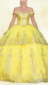 This striking yellow Quinceañera dress features an off-the-shoulder neckline and a fitted bodice adorned with intricate silver embroidery. The voluminous ballroom skirt is layered and showcases detailed patterns that complement the overall design, creating a stunning silhouette perfect for a celebration. The vibrant yellow hue accentuates the dress's elegance, while the shimmering silver details add a touch of radiance.