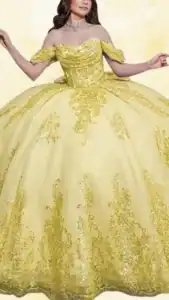 This yellow Quinceañera dress features an off-the-shoulder neckline with delicate ruffled sleeves and a fitted bodice adorned with intricate gold sequined embellishments. The voluminous skirt cascades gracefully in a ball gown style, accented by shimmering patterns that flow into a scalloped hemline. The vibrant yellow hue is complemented by golden accents, creating a striking and elegant appearance.